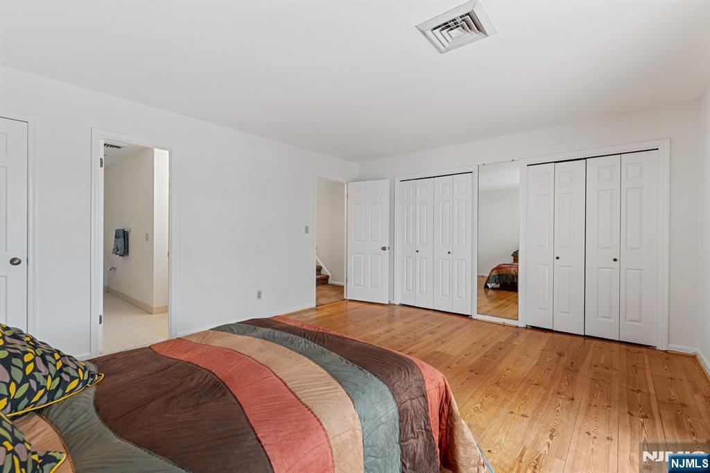 300 Gorge Road, Unit 25 Cliffside Park, NJ 07010 - Photo 25 of 45 a bedroom with a bed and a painting on the wall