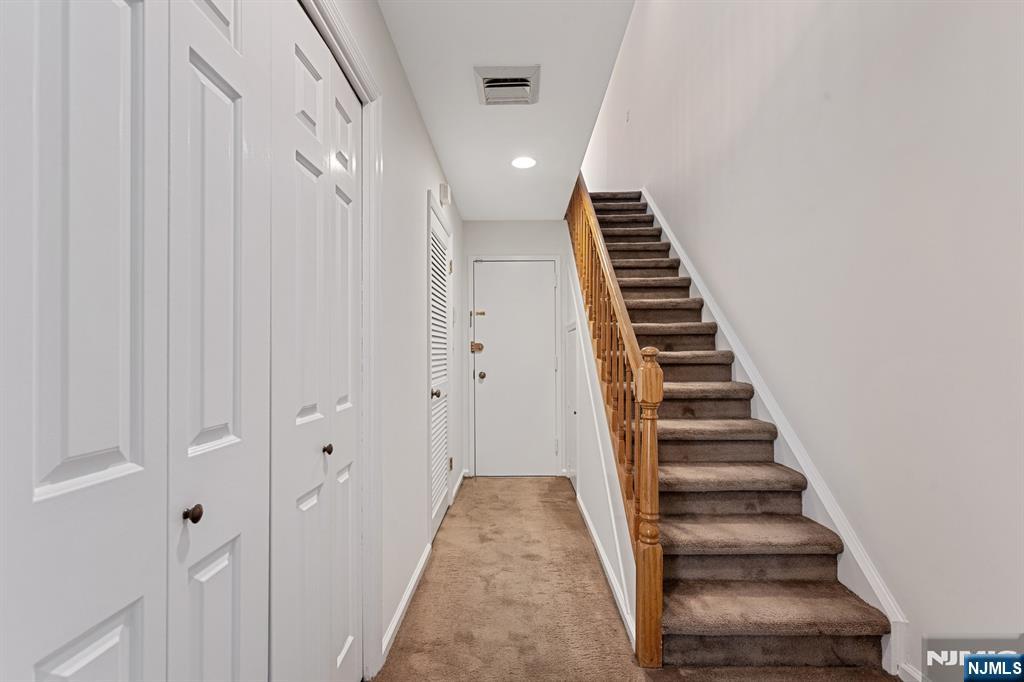 300 Gorge Road, Unit 25 Cliffside Park, NJ 07010 - Photo 29 of 45 a view of a hallway with stairs and wooden floor