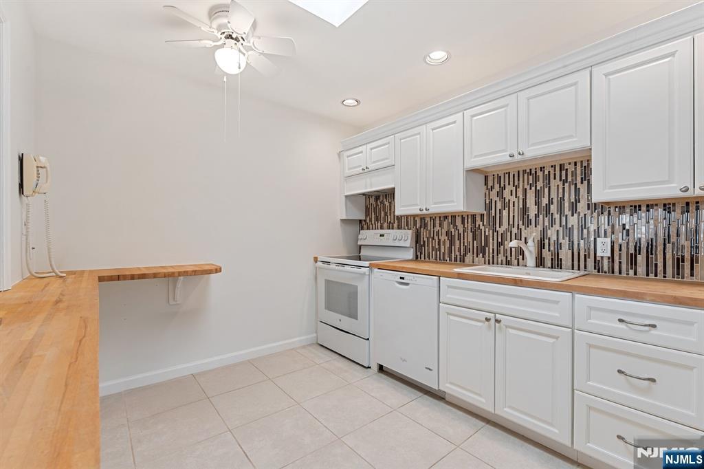 300 Gorge Road, Unit 25 Cliffside Park, NJ 07010 - Photo 6 of 45 a kitchen with white cabinets and white appliances