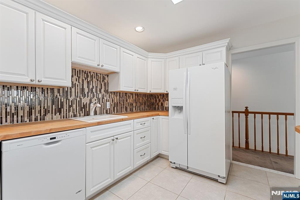 300 Gorge Road, Unit 25 Cliffside Park, NJ 07010 - Photo 8 of 45 a kitchen with white cabinets and sink