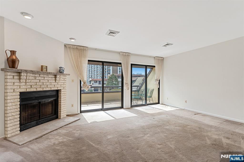 300 Gorge Road, Unit 25 Cliffside Park, NJ 07010 - Photo 10 of 45 a view of an empty room with a fireplace