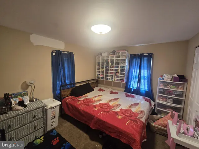 a bedroom with a bed and a dresser in it