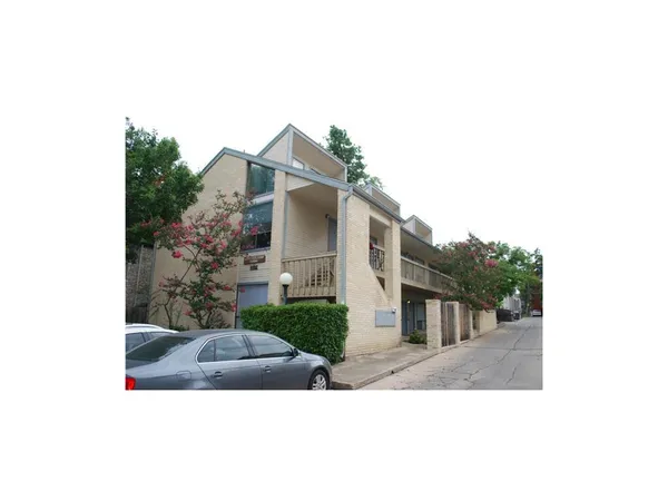 a view of a house with a small yard and plants