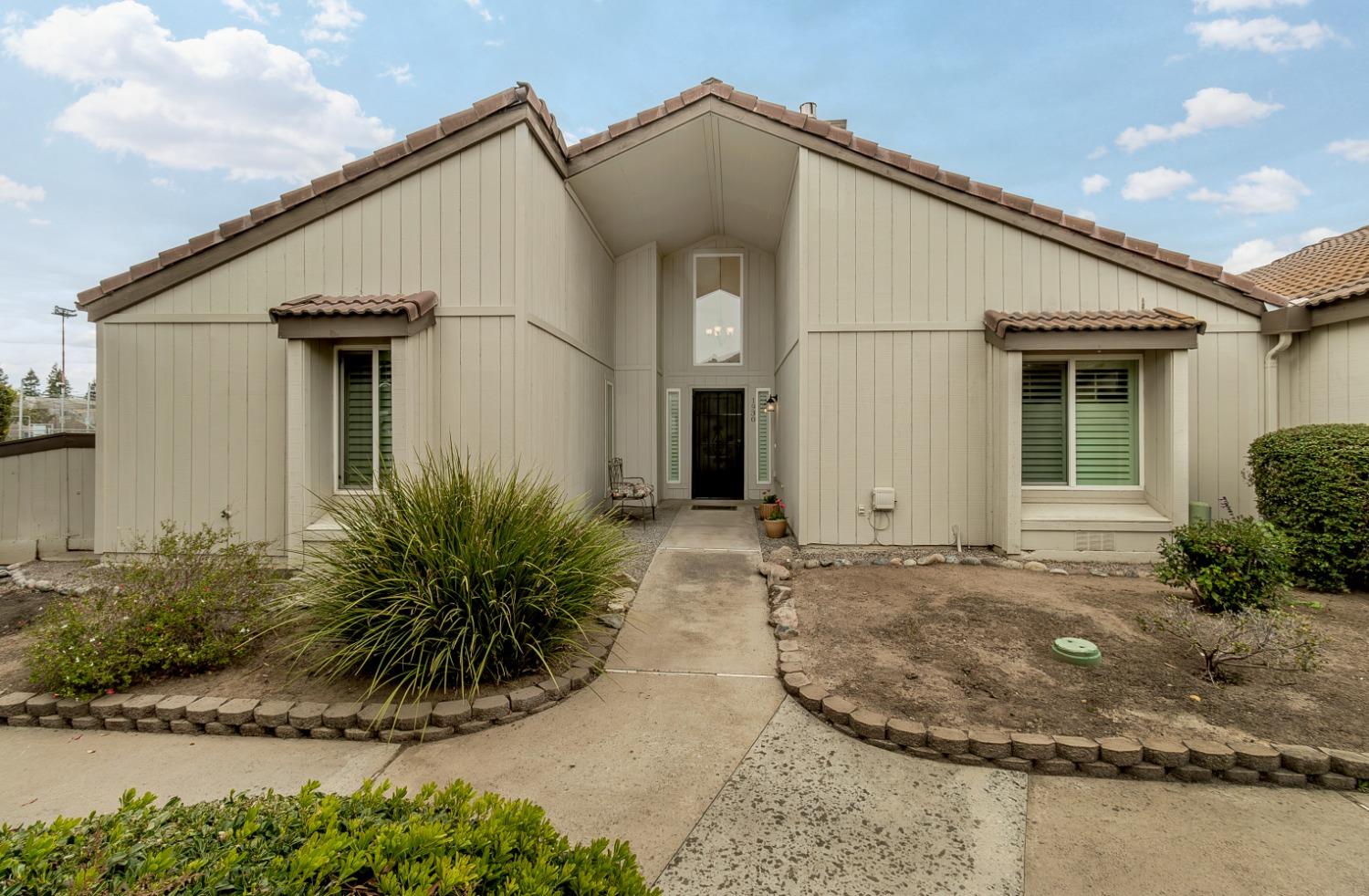 1930 Cougar Lane Clovis, CA 93611 - Photo 1 of 34 a view of a white house next to a yard