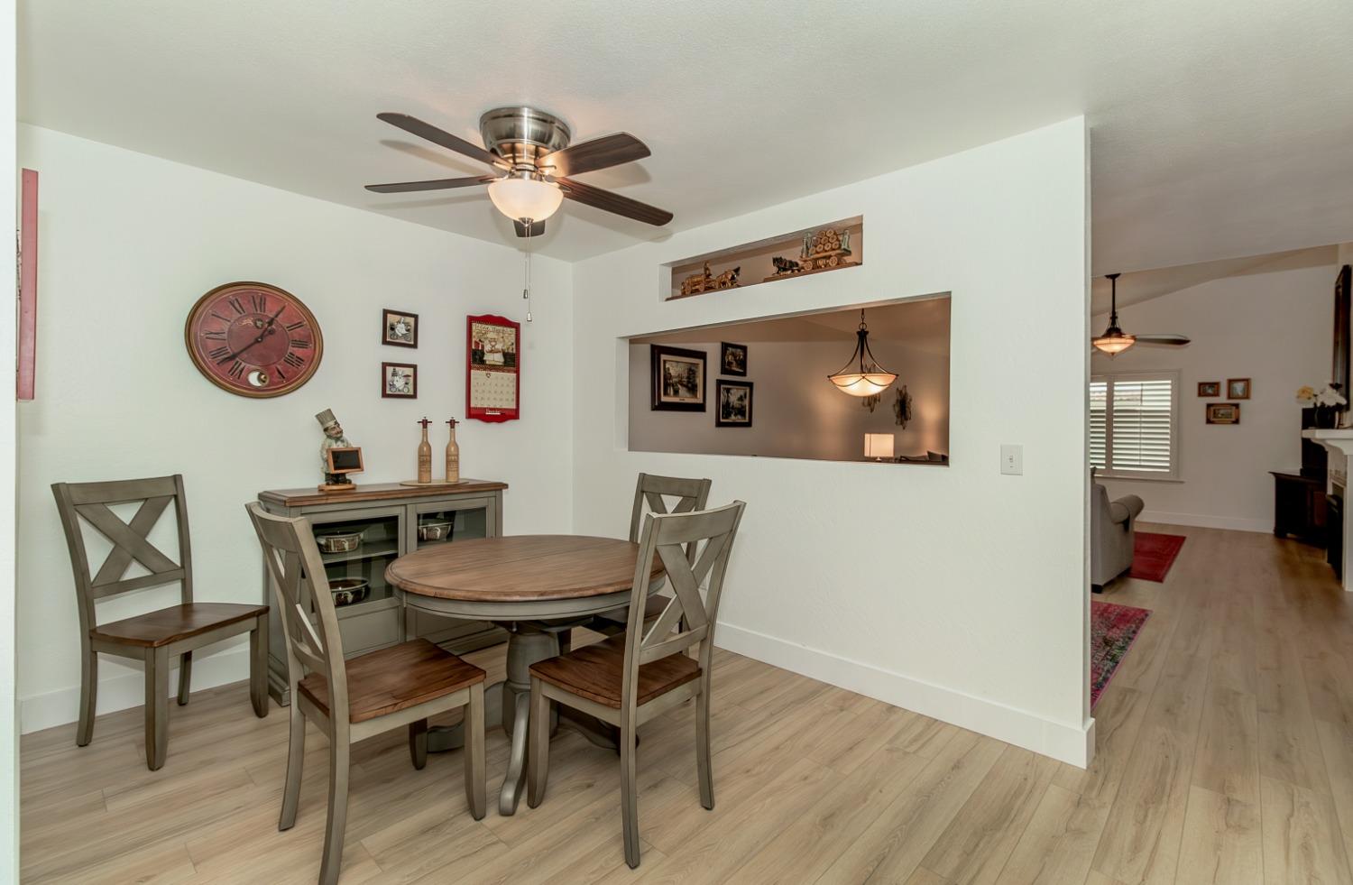 1930 Cougar Lane Clovis, CA 93611 - Photo 11 of 34 a view of a dining room with furniture and wooden floor