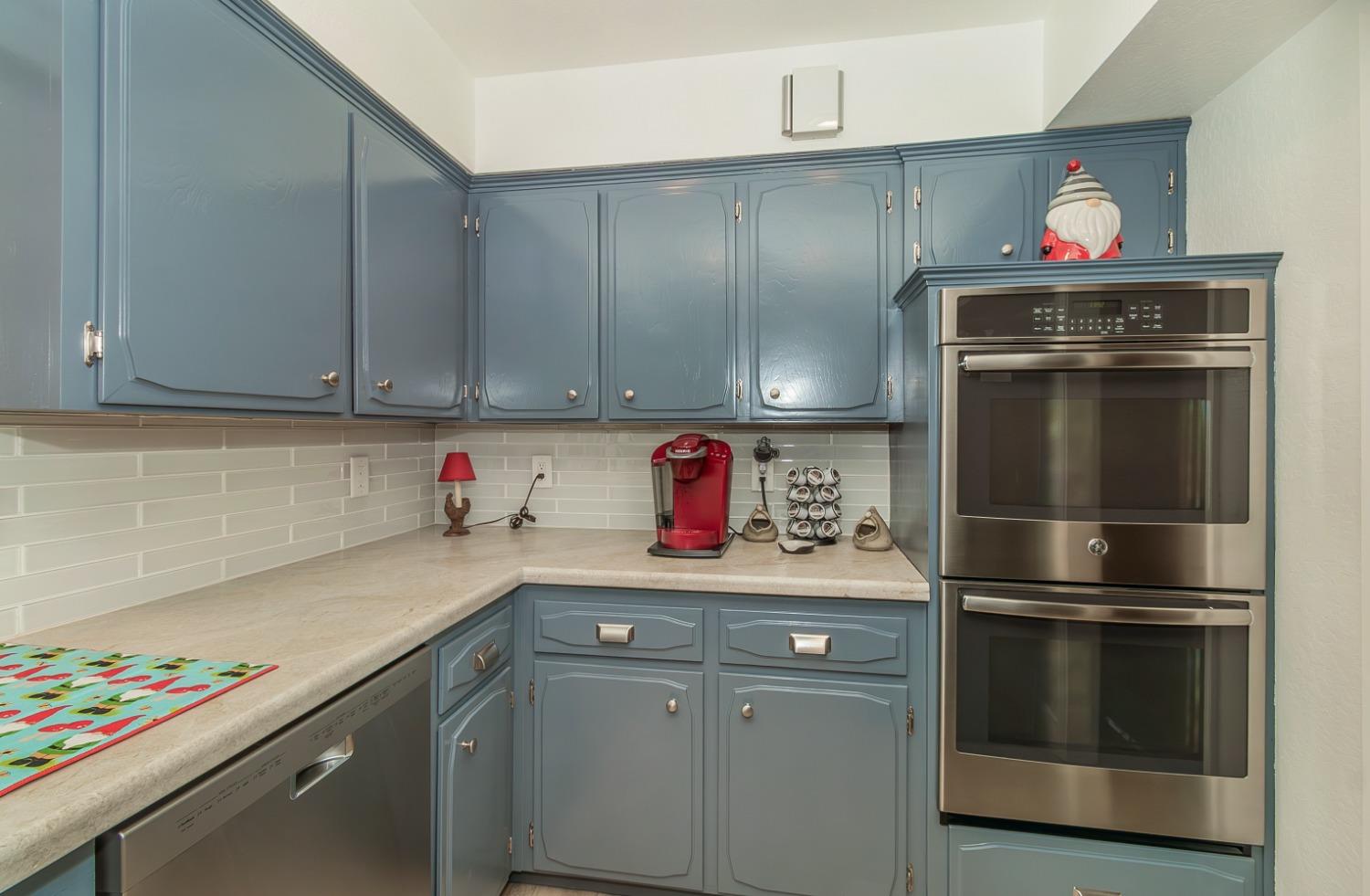 1930 Cougar Lane Clovis, CA 93611 - Photo 14 of 34 a kitchen with stainless steel appliances granite countertop a sink and a refrigerator