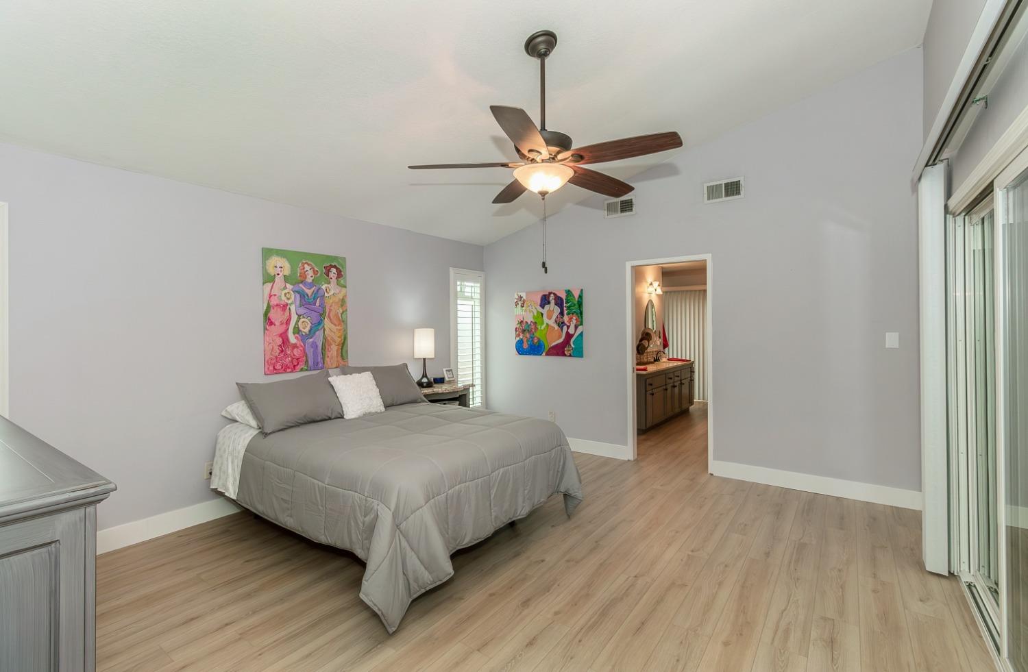 1930 Cougar Lane Clovis, CA 93611 - Photo 18 of 34 a bedroom with a bed and a chandelier