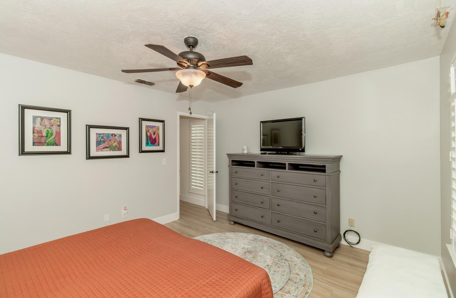 1930 Cougar Lane Clovis, CA 93611 - Photo 28 of 34 a bedroom with a bed and a tv