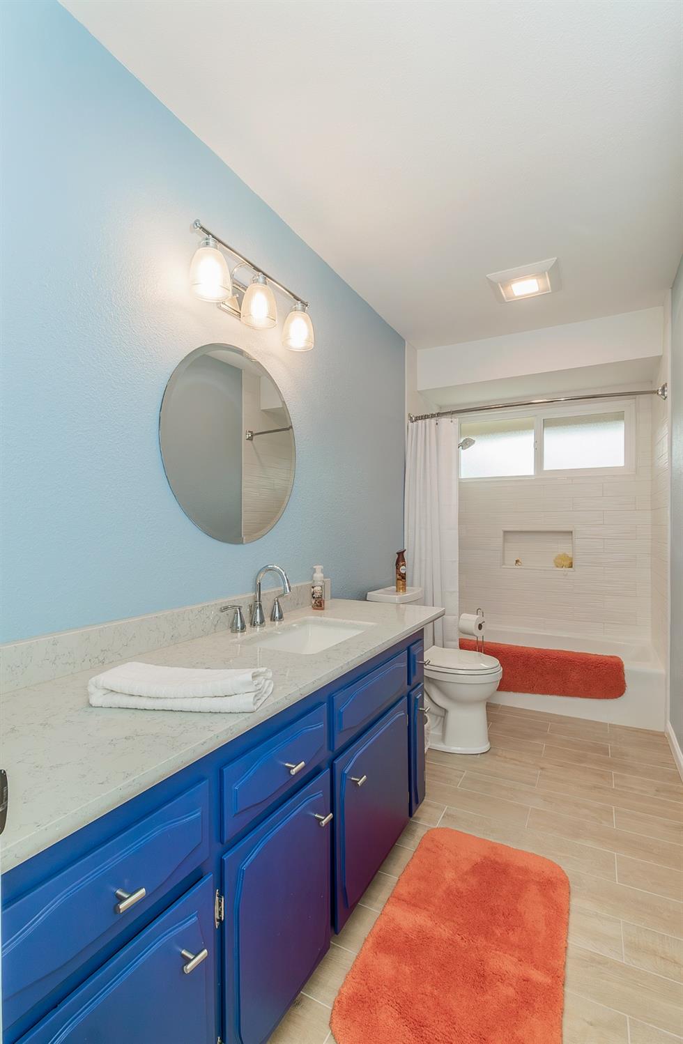 1930 Cougar Lane Clovis, CA 93611 - Photo 29 of 34 a spacious bathroom with a double vanity sink toilet mirror and bathtub