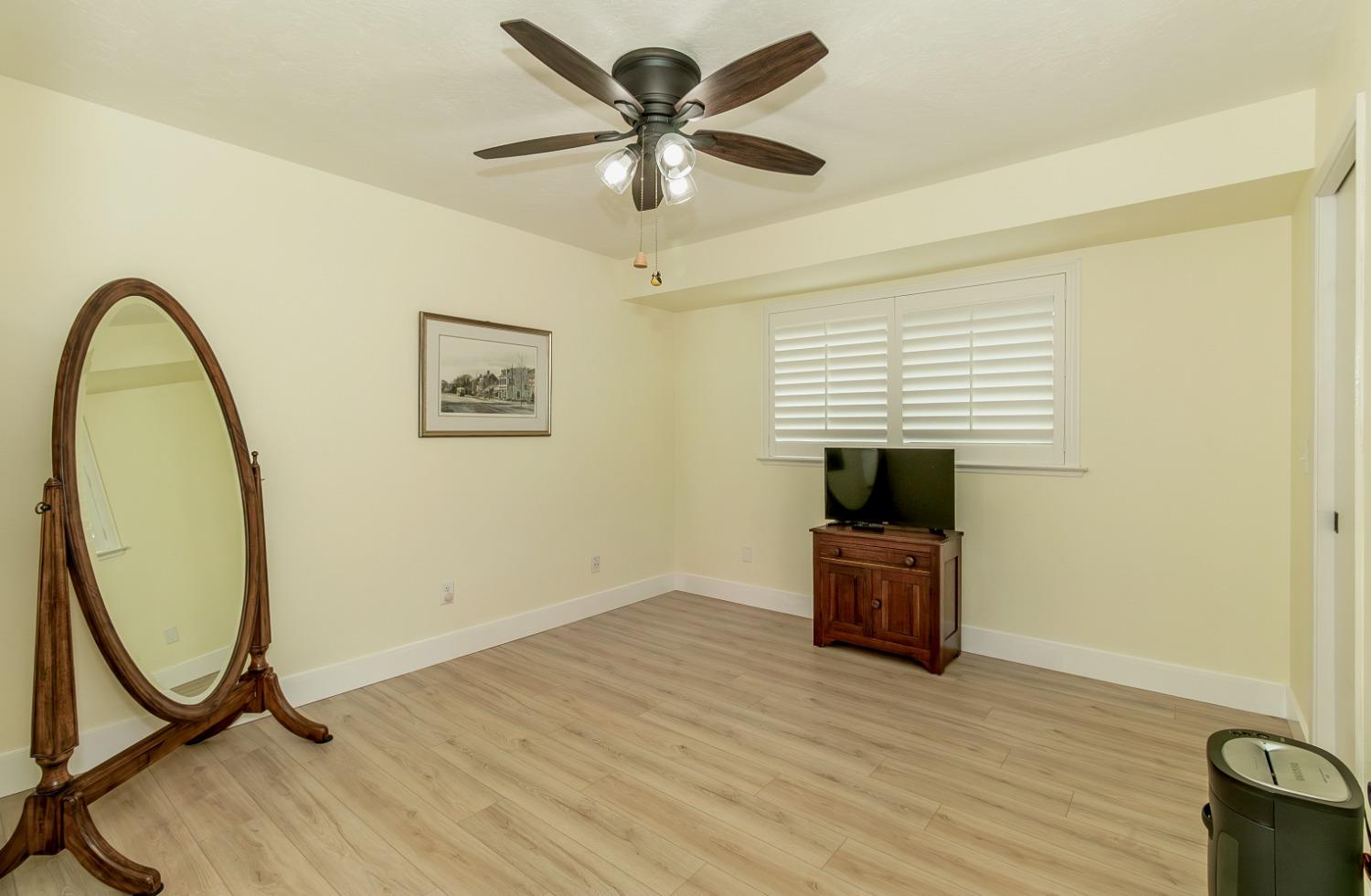 1930 Cougar Lane Clovis, CA 93611 - Photo 31 of 34 a view of a livingroom with a hardwood floor and a ceiling fan
