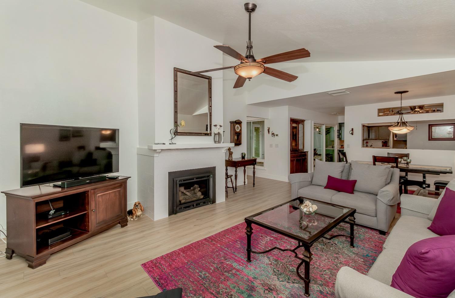 1930 Cougar Lane Clovis, CA 93611 - Photo 5 of 34 a living room with furniture a flat screen tv and a fireplace