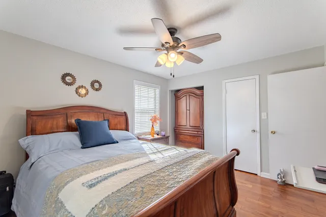 a bedroom with a bed and a chandelier