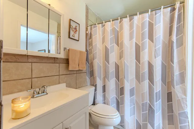 a bathroom with a sink toilet and shower