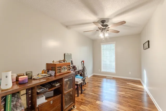 a view of a workspace with furniture and a window