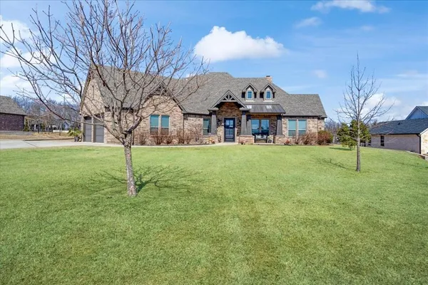 a house that has a tree in front of it