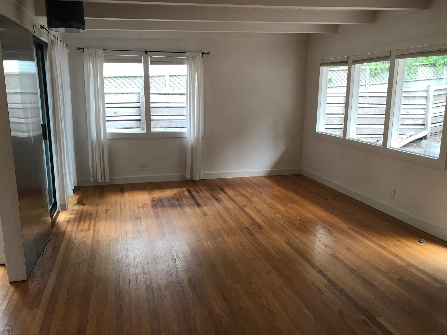 3-12th Junipero Avenue Carmel, CA 93923 - Photo 3 of 14 a view of an empty room with wooden floor and a window