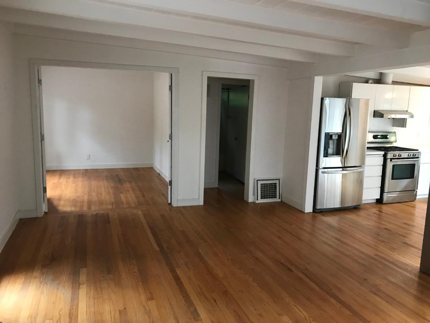 3-12th Junipero Avenue Carmel, CA 93923 - Photo 6 of 14 a view of a hardwood floor in an empty room with a window