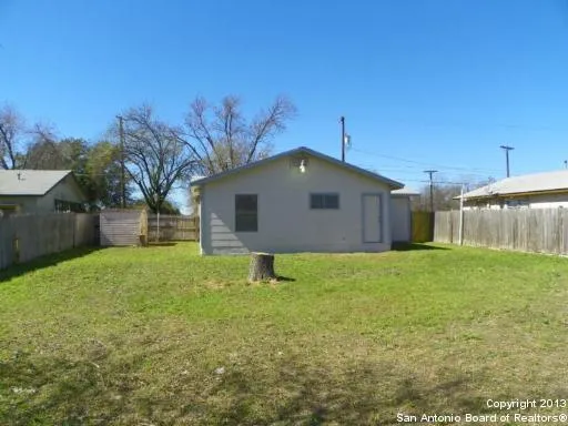 a yellow house with garden in front of it