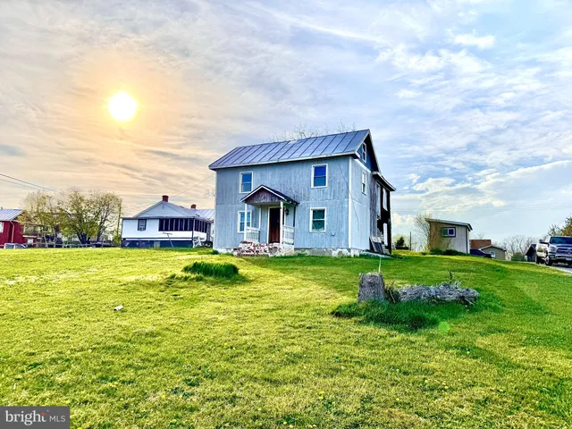 a house view with swimming pool in front of it