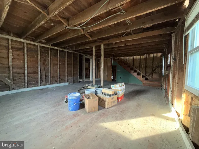 a view of a patio with table and chairs and potted plants