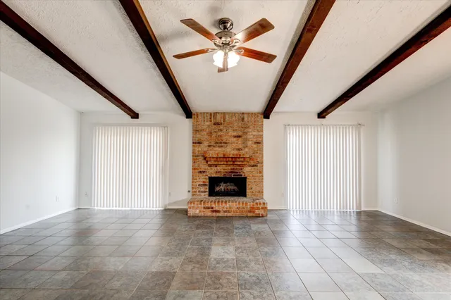 a view of a hallway with furniture and a window