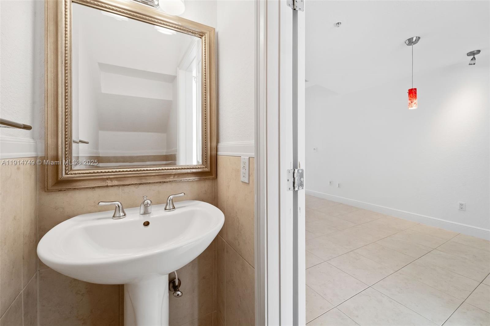 8041 Harding Avenue, Unit 105 Miami Beach, FL 33141 - Photo 7 of 23 a bathroom with a sink and a mirror