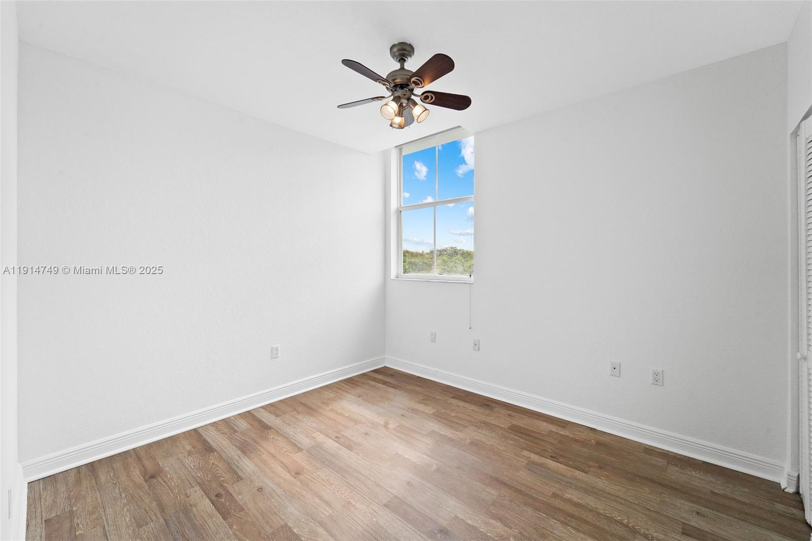 8041 Harding Avenue, Unit 105 Miami Beach, FL 33141 - Photo 10 of 23 an empty room with wooden floor and ceiling fan