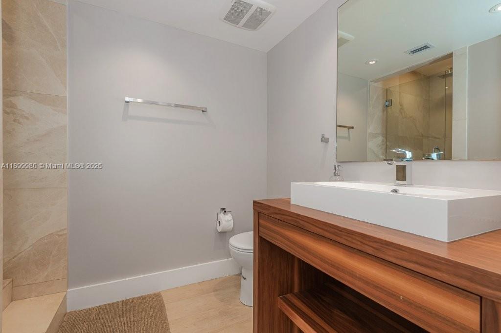 2301 Collins Avenue, Unit 738 Miami Beach, FL 33139 - Photo 17 of 33 a bathroom with a sink and a toilet