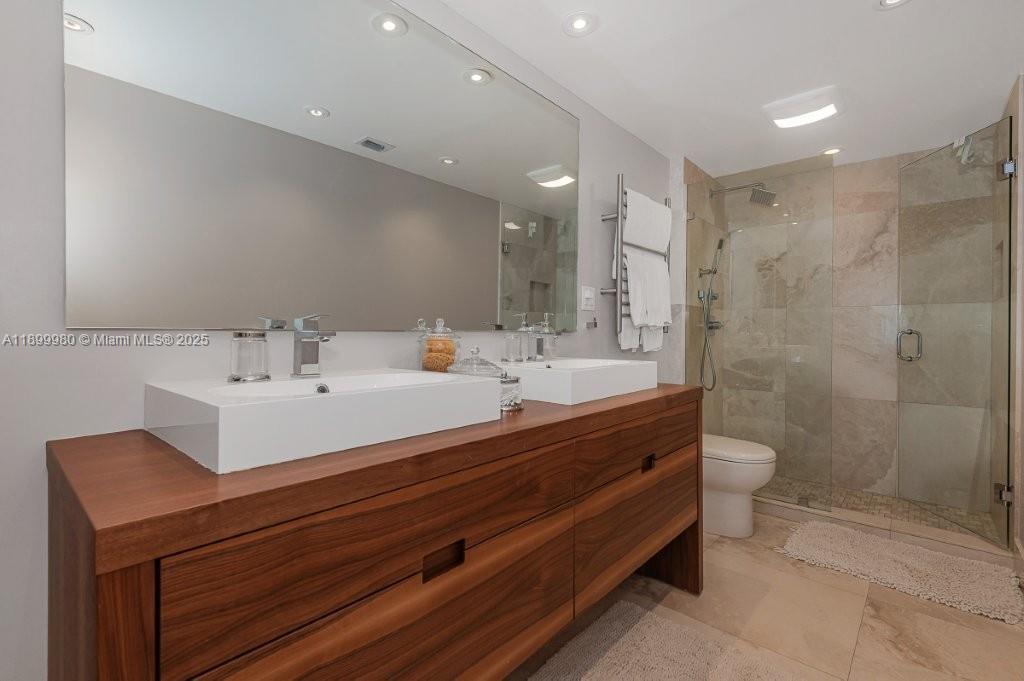 2301 Collins Avenue, Unit 738 Miami Beach, FL 33139 - Photo 4 of 33 a bathroom with a double vanity sink toilet and shower