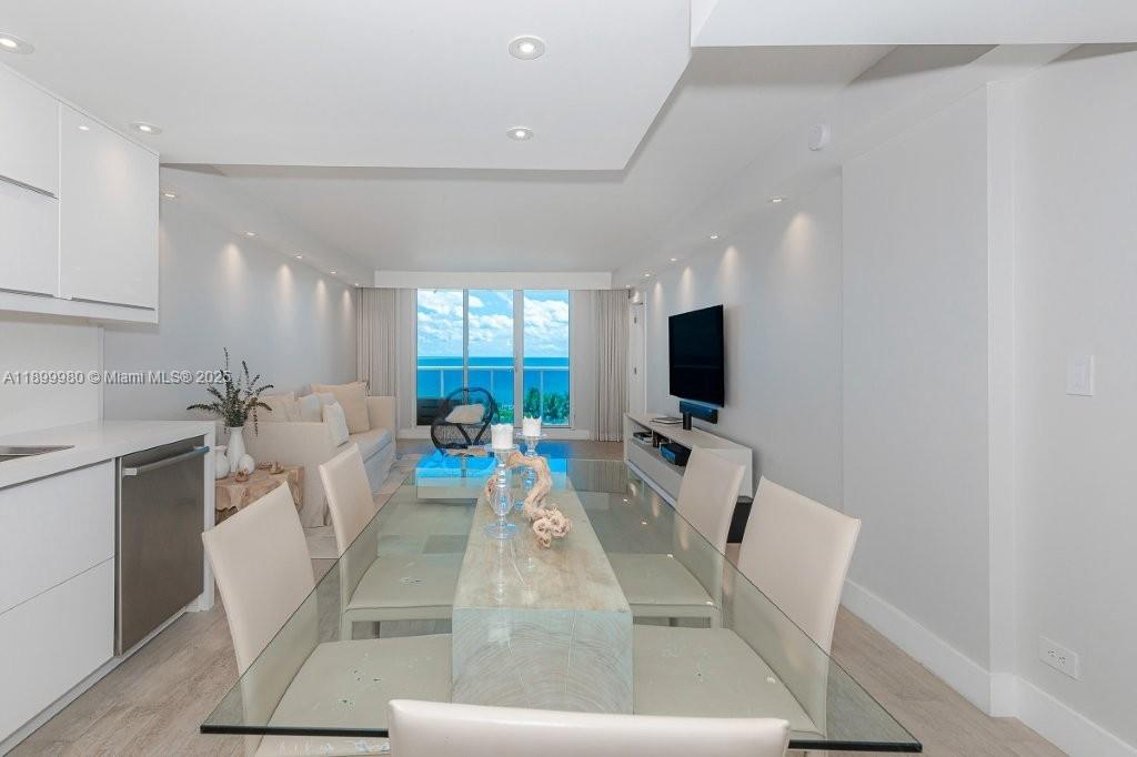 2301 Collins Avenue, Unit 738 Miami Beach, FL 33139 - Photo 7 of 33 a living room with furniture and a flat screen tv