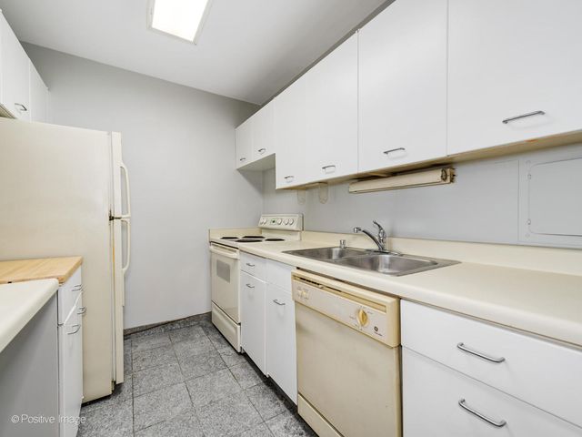 a utility room with cabinets washer and dryer