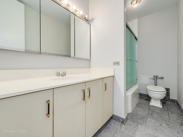 a bathroom with a sink mirror and toilet