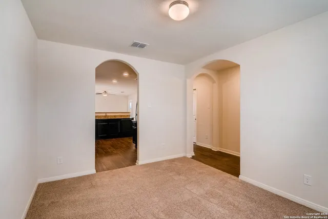 a view of a hallway with wooden floor and entryway