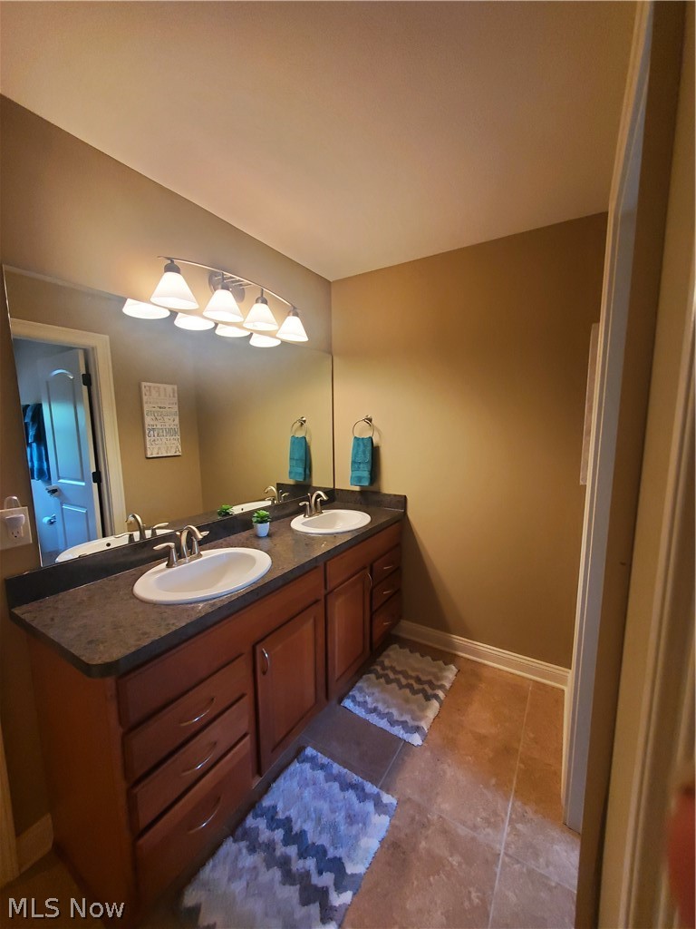 8261 Rodgers Road Lodi, OH 44254 - Photo 26 of 35 Full bath on 2nd floor with double sinks, full mirror, linen closet, private shower & commode and ceramic tile flooring.