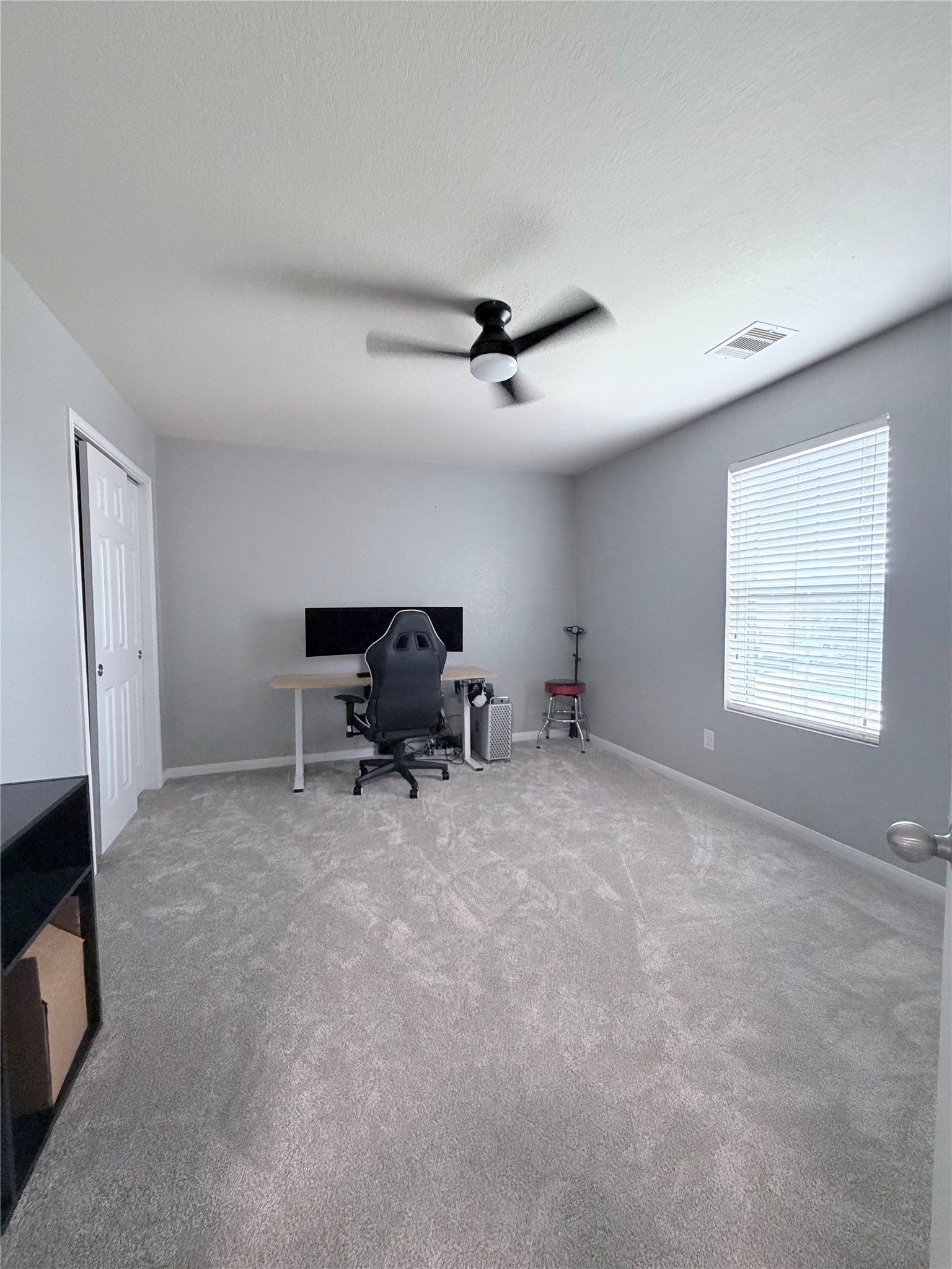 3226 Dappled Vale Trail Spring, TX 77373 - Photo 14 of 26 Carpeted room with neutral walls, featuring a ceiling fan and a window with blinds. It's set up as a home office with a desk, chair, and computer. Ideal for a workspace or bedroom.