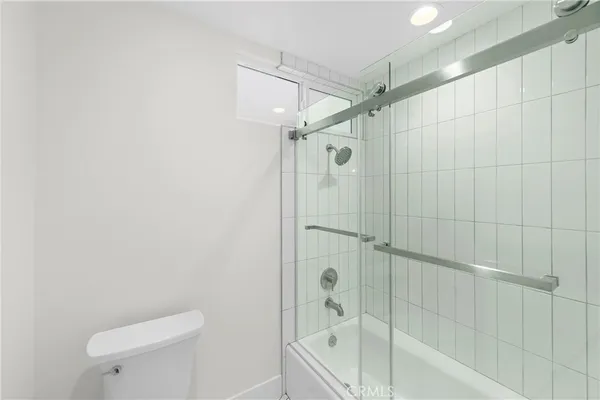 a bathroom with a shower a toilet and sink