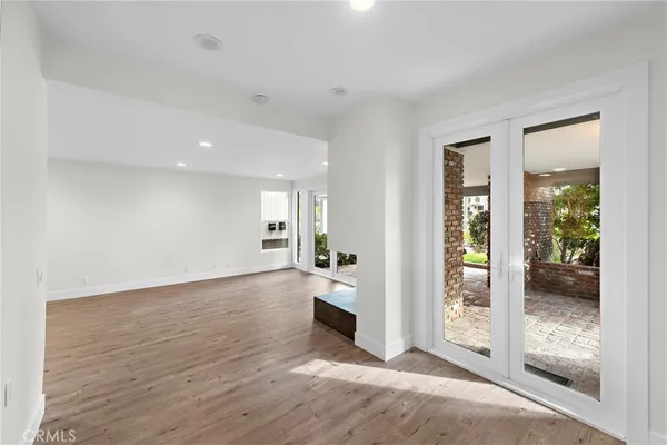 wooden floor in an empty room with a glass door
