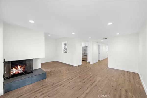 a view of an empty room with a fireplace and a fireplace