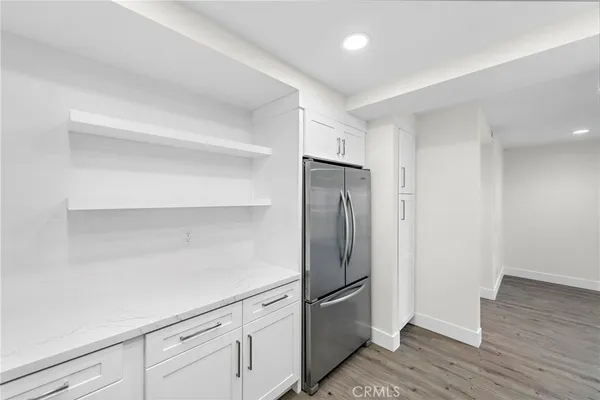 a kitchen with a refrigerator and cabinets