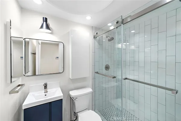 a bathroom with a sink toilet and shower