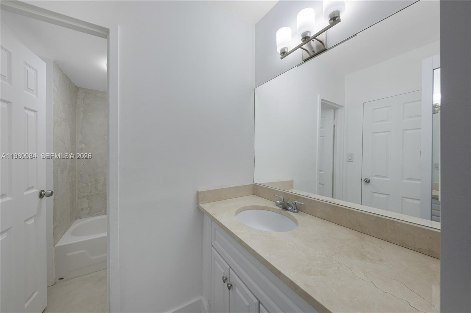 100 Lincoln Road, Unit 626 Miami Beach, FL 33139 - Photo 2 of 12 a bathroom with a granite countertop sink a toilet and shower