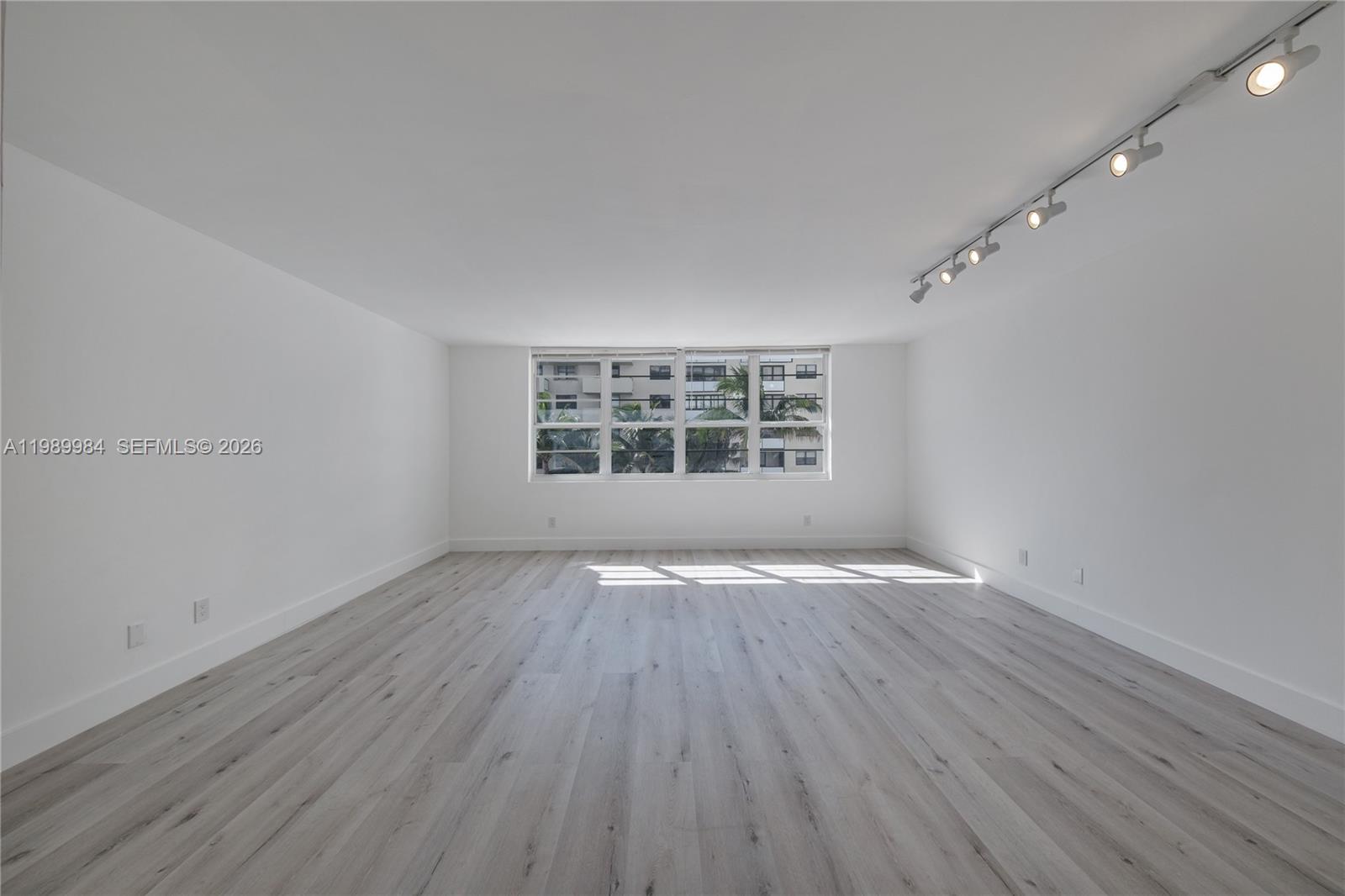 100 Lincoln Road, Unit 626 Miami Beach, FL 33139 - Photo 3 of 12 wooden floor in an empty room with a window