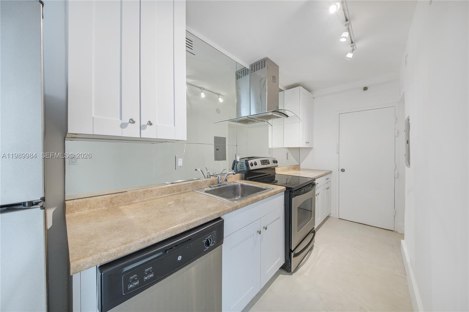 100 Lincoln Road, Unit 626 Miami Beach, FL 33139 - Photo 8 of 12 a kitchen with a sink stove and cabinets