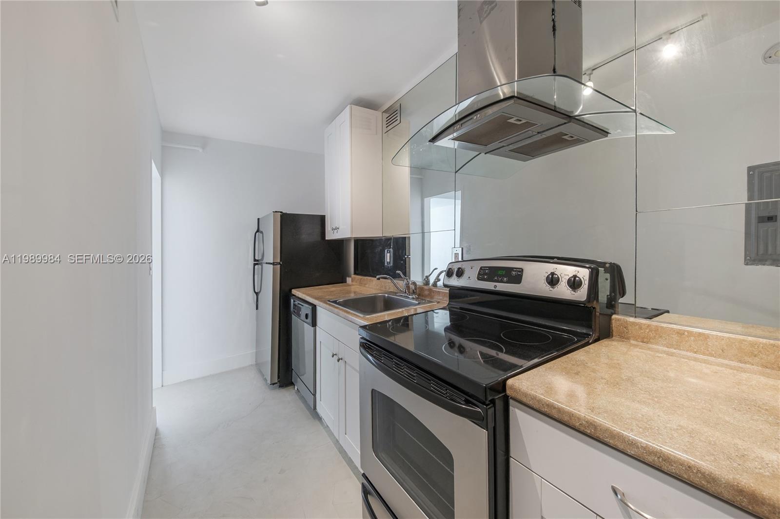 100 Lincoln Road, Unit 626 Miami Beach, FL 33139 - Photo 9 of 12 a kitchen with a stove and a microwave
