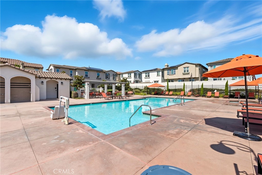 4211 Mission Ranch Way Oceanside, CA 92057 - Photo 32 of 40 a multi story building with lawn chairs and iron fence