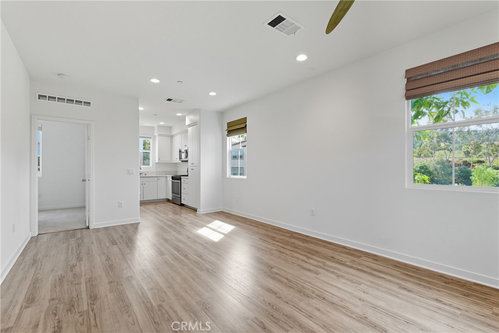 4211 Mission Ranch Way Oceanside, CA 92057 - Photo 4 of 40 a view of an empty room with wooden floor and a window