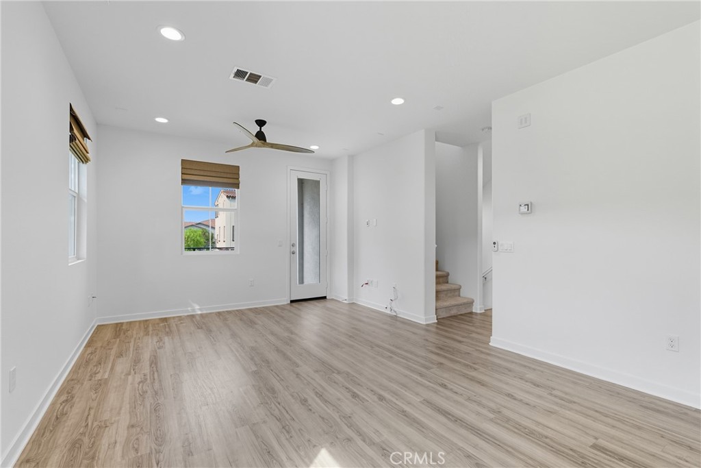 4211 Mission Ranch Way Oceanside, CA 92057 - Photo 6 of 40 a view of an empty room with wooden floor and a window