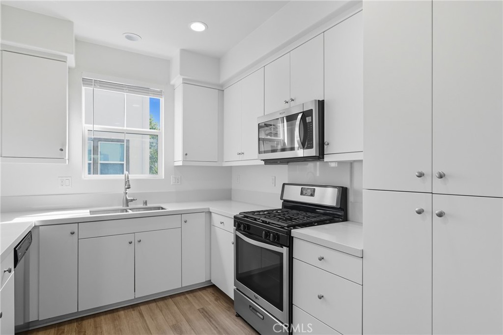 4211 Mission Ranch Way Oceanside, CA 92057 - Photo 8 of 40 a kitchen with cabinets appliances a sink and a window