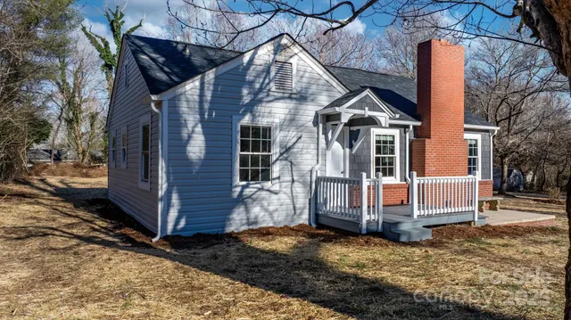 a view of a house with a yard covered in snow