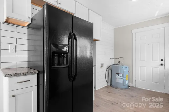 a kitchen with metallic refrigerator freezer and a dishwasher